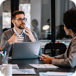Man uses hands to explain results during a business meeting
